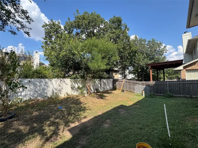 a view of a house with yard and sitting area