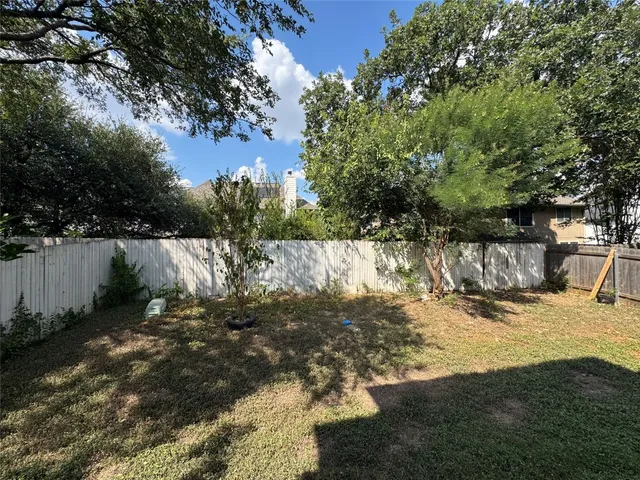 a view of a yard with a tree
