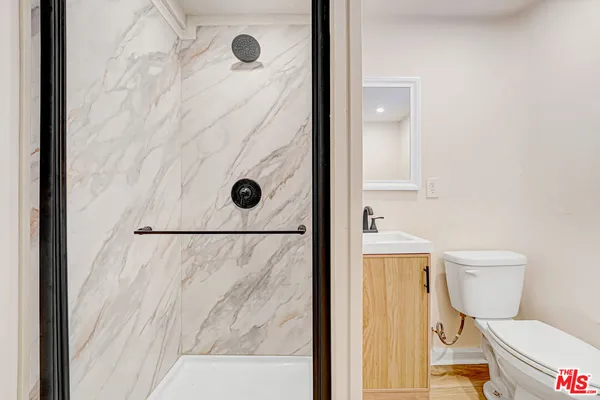 a bathroom with a toilet and a shower