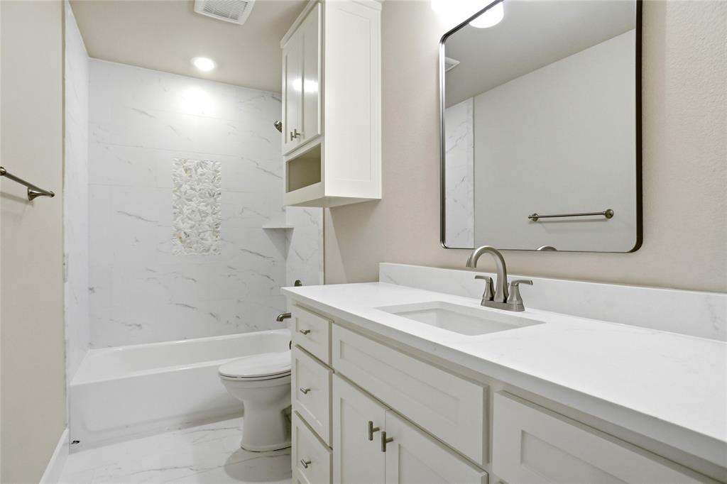 133 Joel Street Springtown, TX 76082 - Photo 13 of 15 a bathroom with a sink a toilet and shower