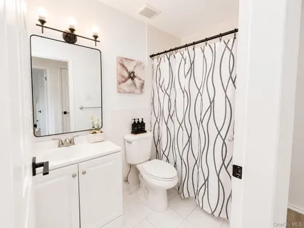 a white toilet sitting next to a bathroom sink