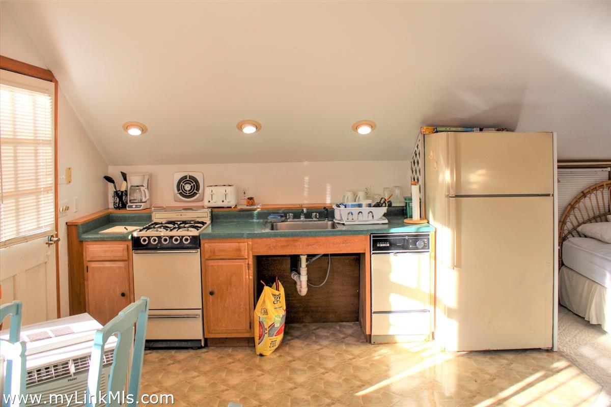 8 Sea Street Nantucket, MA 02554 - Photo 3 of 7 a kitchen with stainless steel appliances granite countertop a refrigerator and a stove top oven