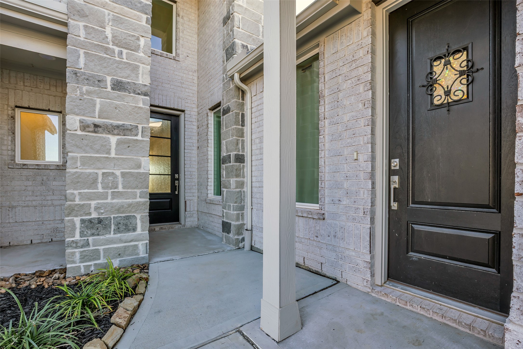 8619 Jade Hl Drive Rosharon, TX 77583 - Photo 4 of 50 Front Entry: A sheltered approach framed by brick and stone creates a quiet sense of arrival. The private Next Gen entrance and main entry are thoughtfully positioned, offering choice, separation, and a welcoming first impression.