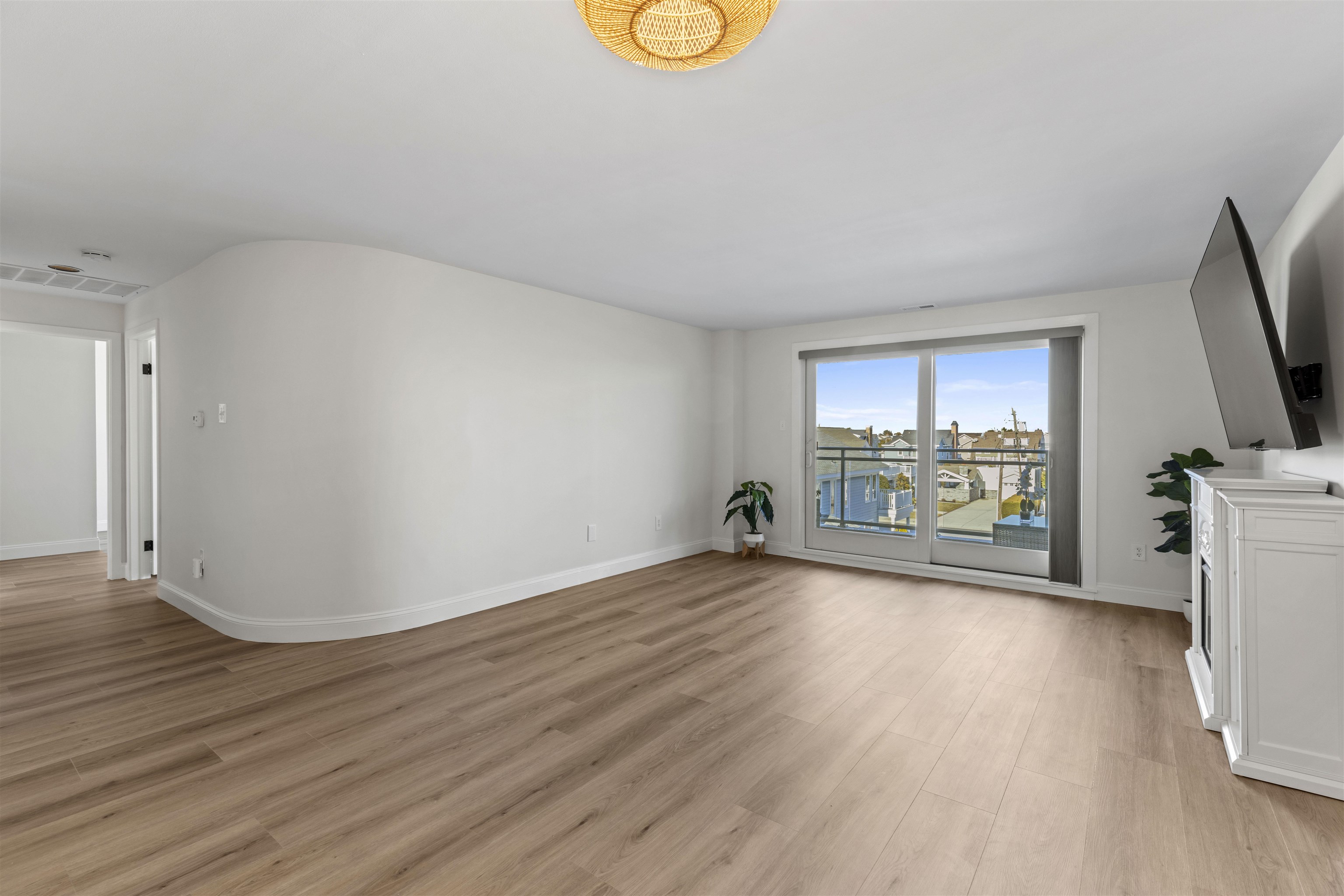 100 96th Street, Unit 304 Stone Harbor, NJ 08247 - Photo 11 of 34 a view of an empty room with a window and wooden floor