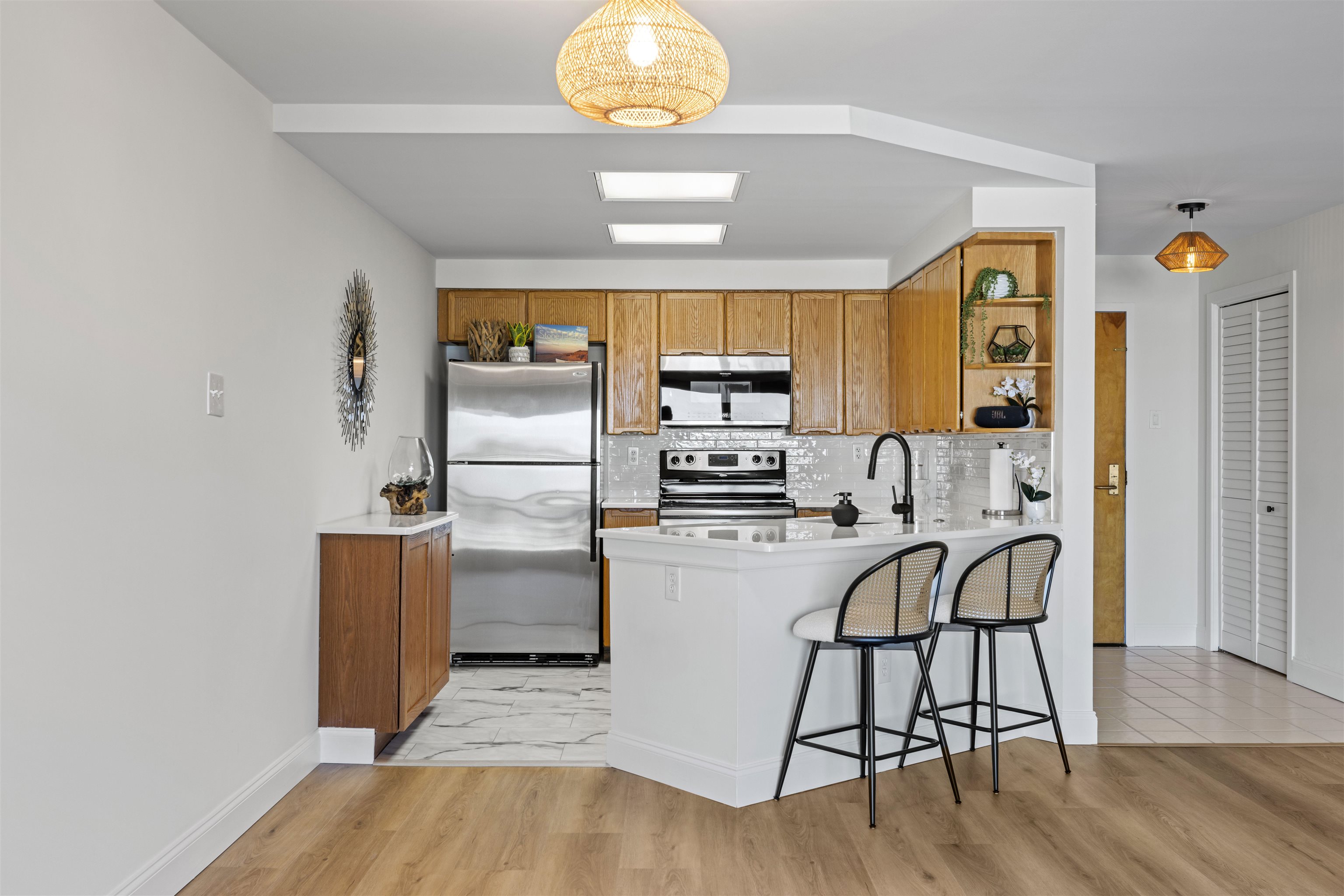 100 96th Street, Unit 304 Stone Harbor, NJ 08247 - Photo 13 of 34 a kitchen with stainless steel appliances a stove a refrigerator cabinets and wooden floor