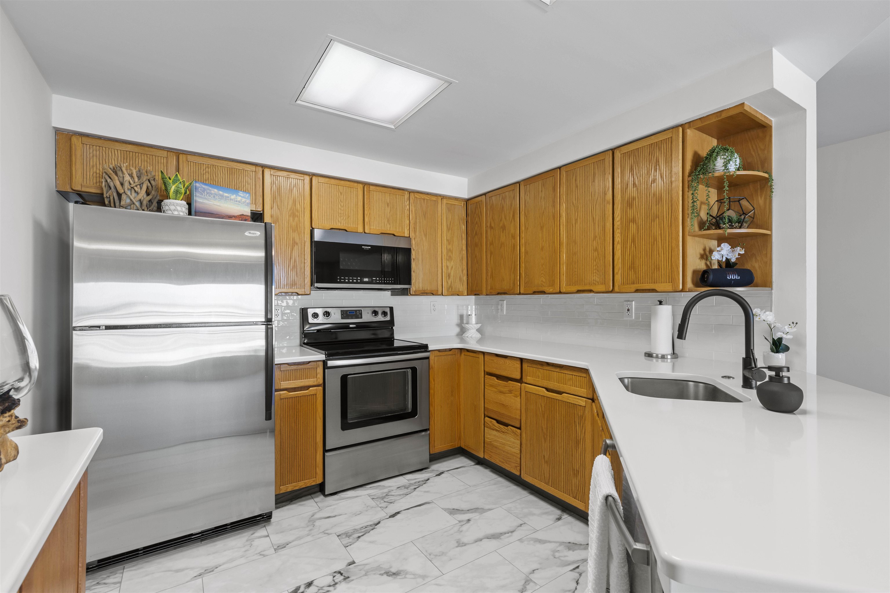 100 96th Street, Unit 304 Stone Harbor, NJ 08247 - Photo 14 of 34 a kitchen with stainless steel appliances granite countertop a sink and a stove