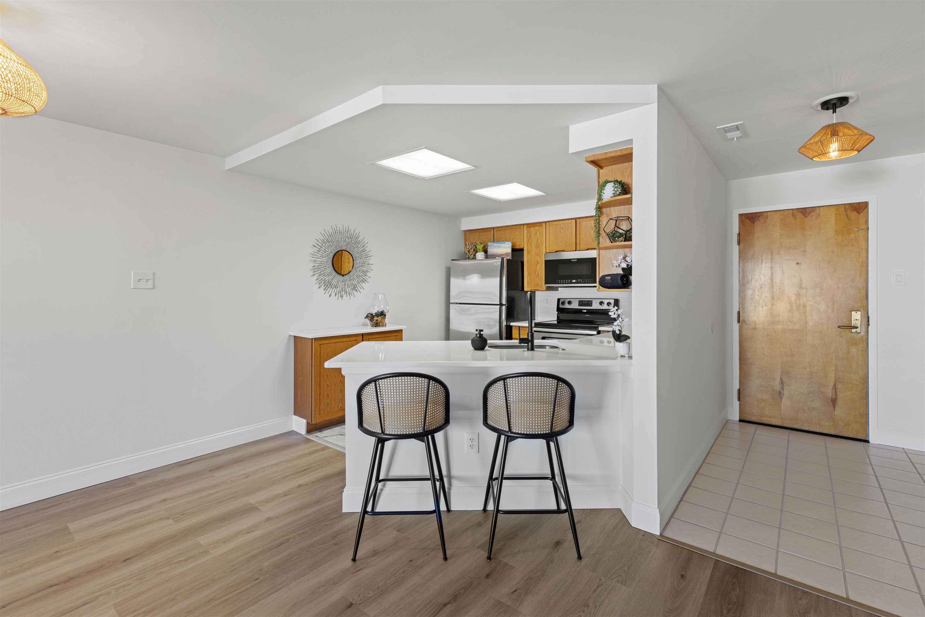 100 96th Street, Unit 304 Stone Harbor, NJ 08247 - Photo 16 of 34 a kitchen with stainless steel appliances granite countertop a sink and a refrigerator
