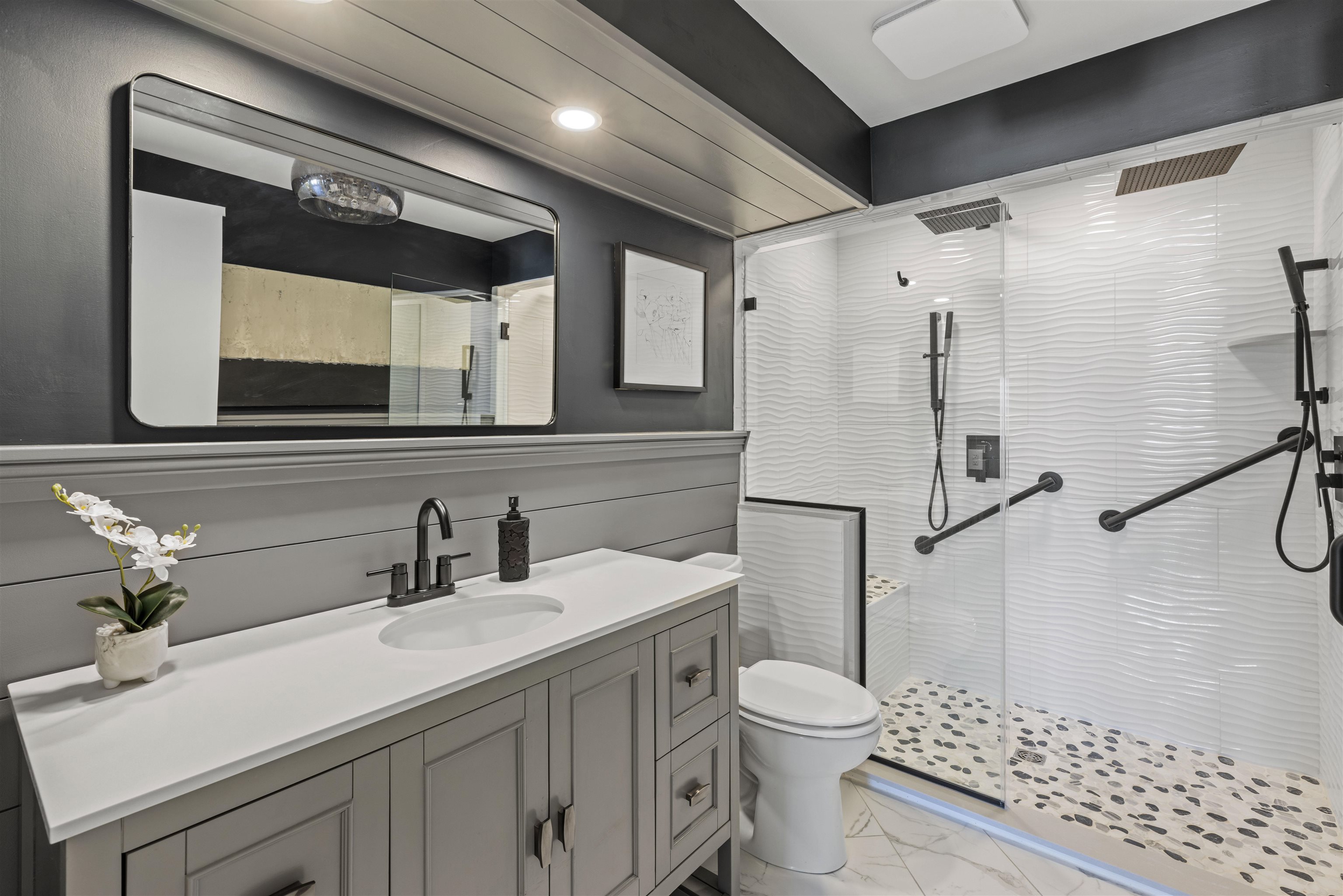 100 96th Street, Unit 304 Stone Harbor, NJ 08247 - Photo 6 of 34 a bathroom with a sink toilet a mirror and shower