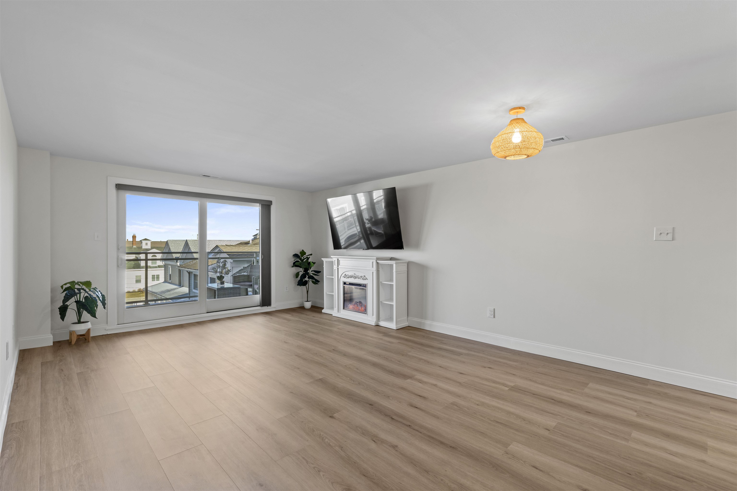 100 96th Street, Unit 304 Stone Harbor, NJ 08247 - Photo 9 of 34 a view of a livingroom with wooden floor and a flat screen tv