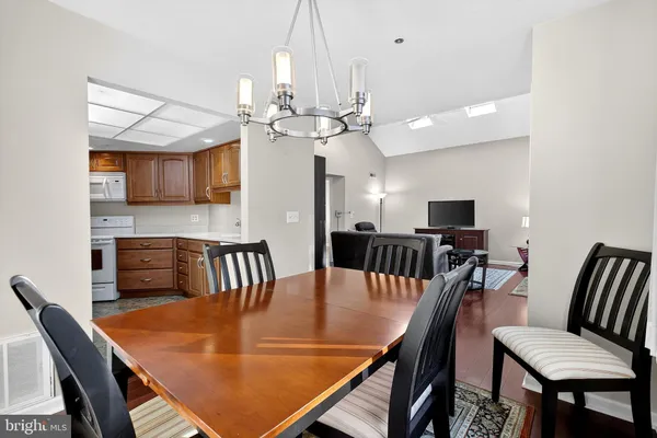 a view of a dining room with furniture and a chandelier