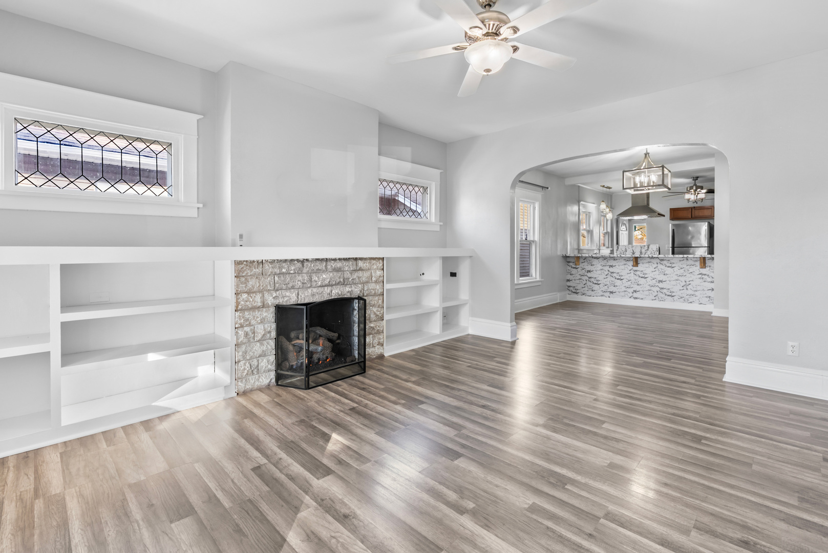 446 Seminary Avenue Aurora, IL 60505 - Photo 2 of 41 a view of an empty room with wooden floor fireplace and a window