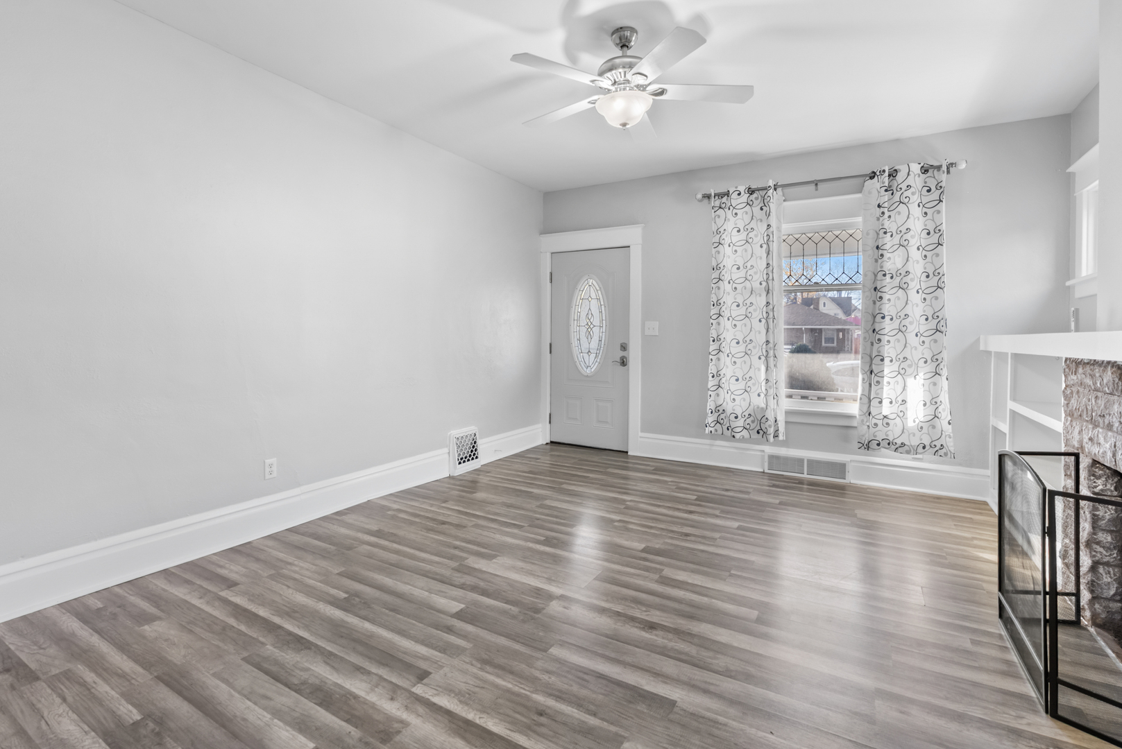 446 Seminary Avenue Aurora, IL 60505 - Photo 3 of 41 a view of empty room with wooden floor and fan