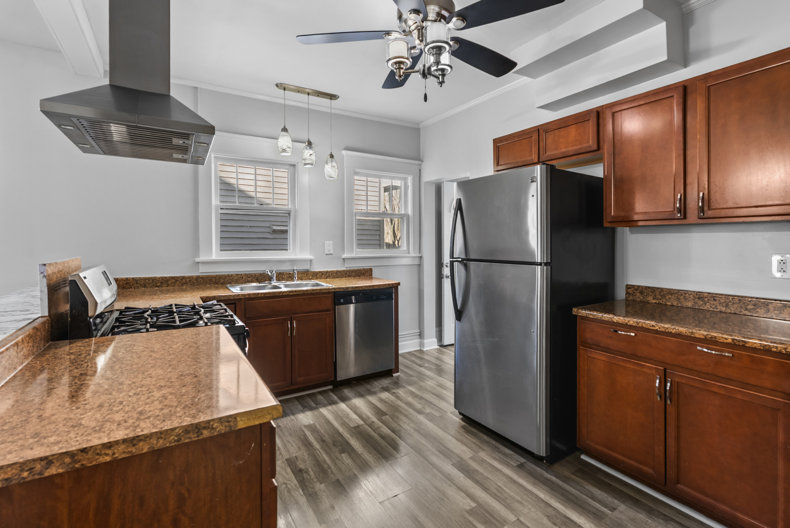 446 Seminary Avenue Aurora, IL 60505 - Photo 7 of 41 a kitchen with stainless steel appliances granite countertop a refrigerator a sink dishwasher a stove and white countertops with wooden floor
