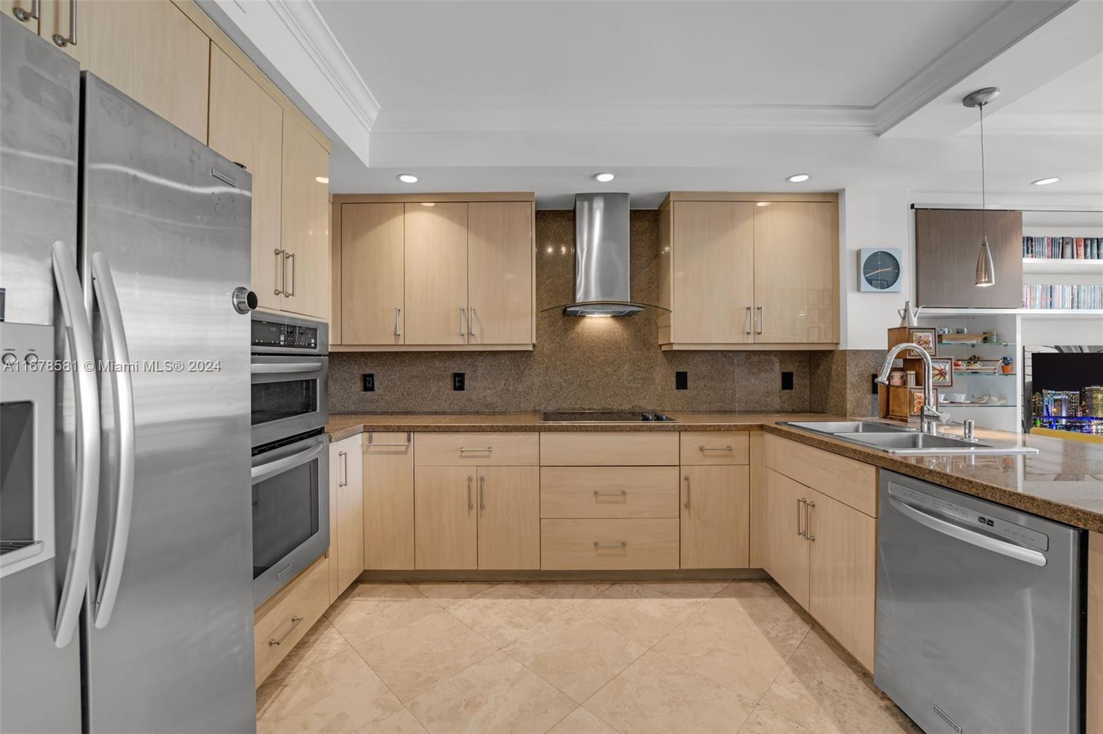 765 Crandon Boulevard, Unit 305 Key Biscayne, FL 33149 - Photo 15 of 55 a kitchen with white cabinets stainless steel appliances and sink