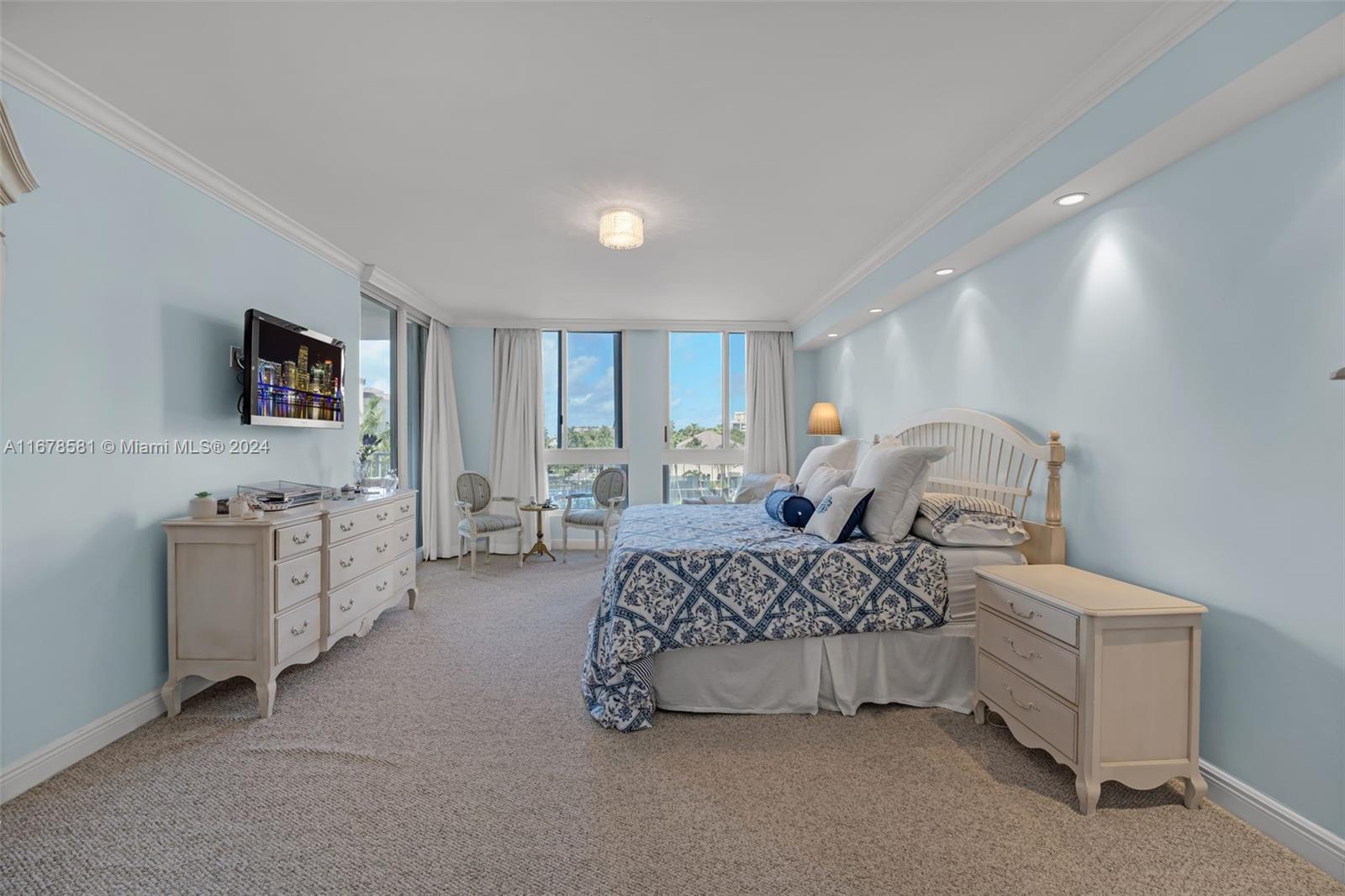 765 Crandon Boulevard, Unit 305 Key Biscayne, FL 33149 - Photo 18 of 55 a bedroom with bed and a chandelier