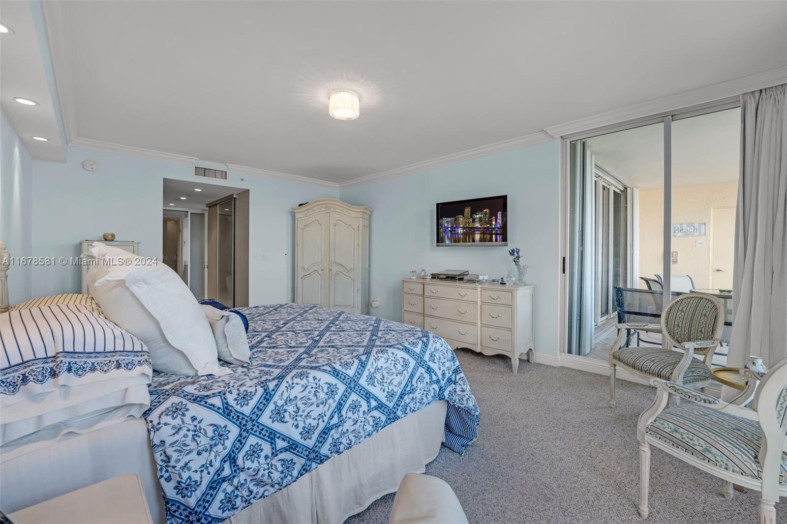 765 Crandon Boulevard, Unit 305 Key Biscayne, FL 33149 - Photo 21 of 55 a bedroom with a bed and a couch