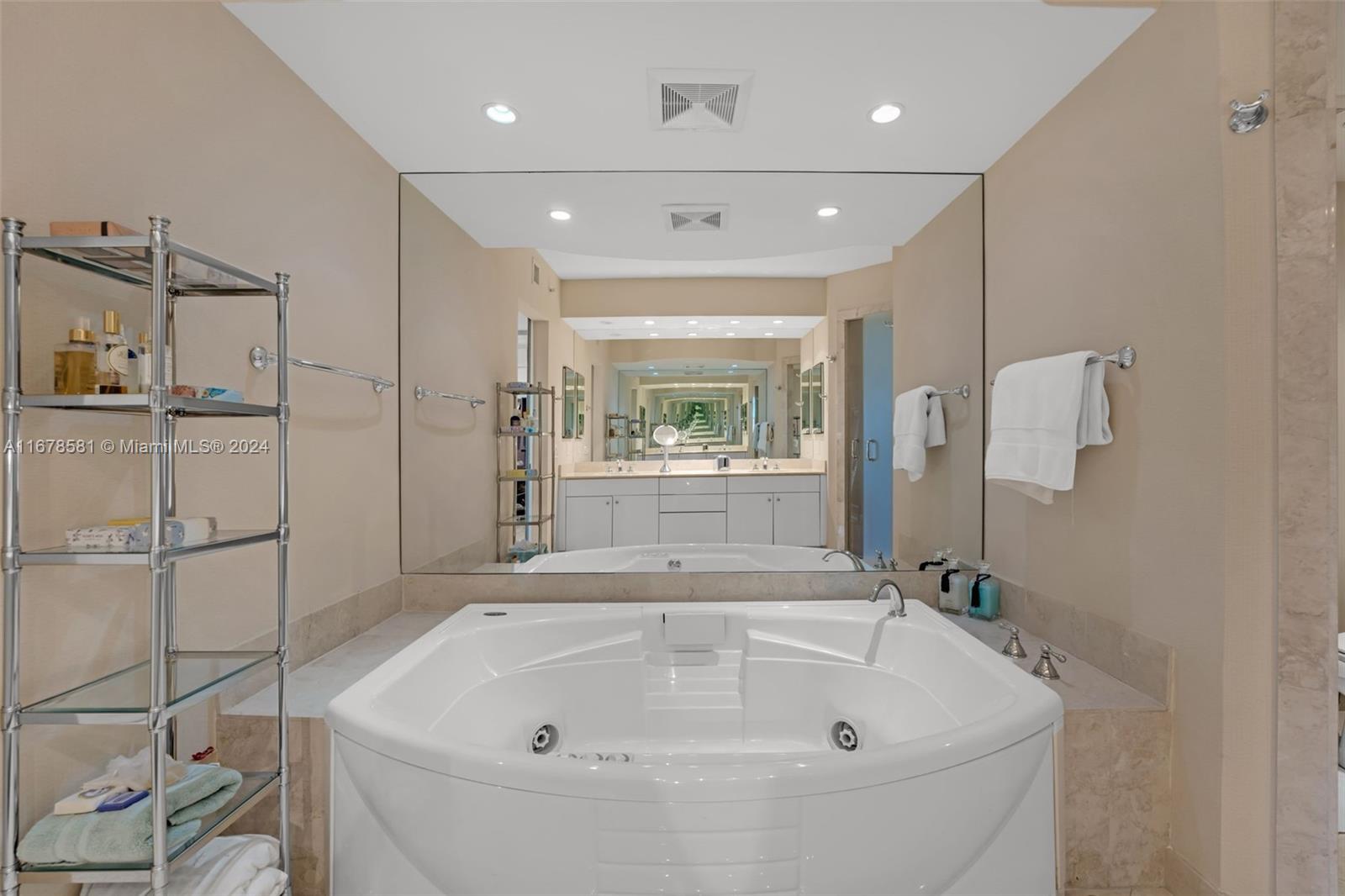 765 Crandon Boulevard, Unit 305 Key Biscayne, FL 33149 - Photo 26 of 55 a bathroom with a bathtub and window