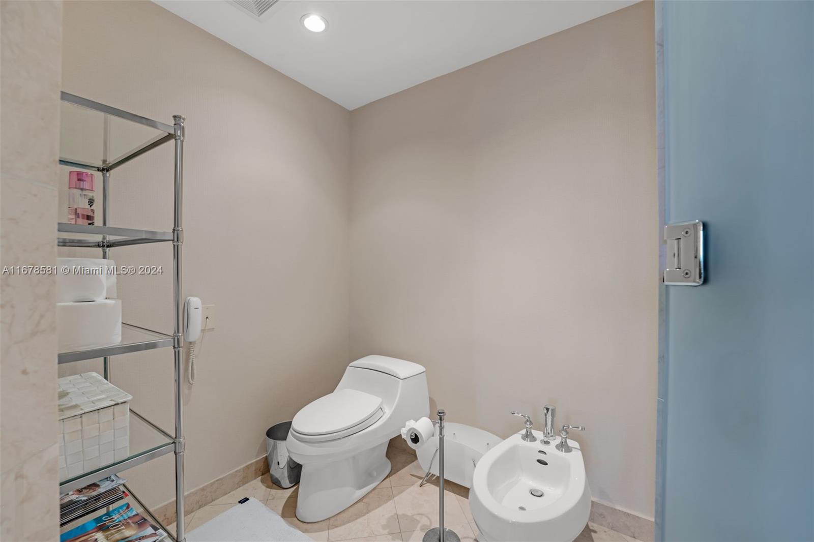 765 Crandon Boulevard, Unit 305 Key Biscayne, FL 33149 - Photo 27 of 55 a white toilet sitting next to a bathroom sink and a shower