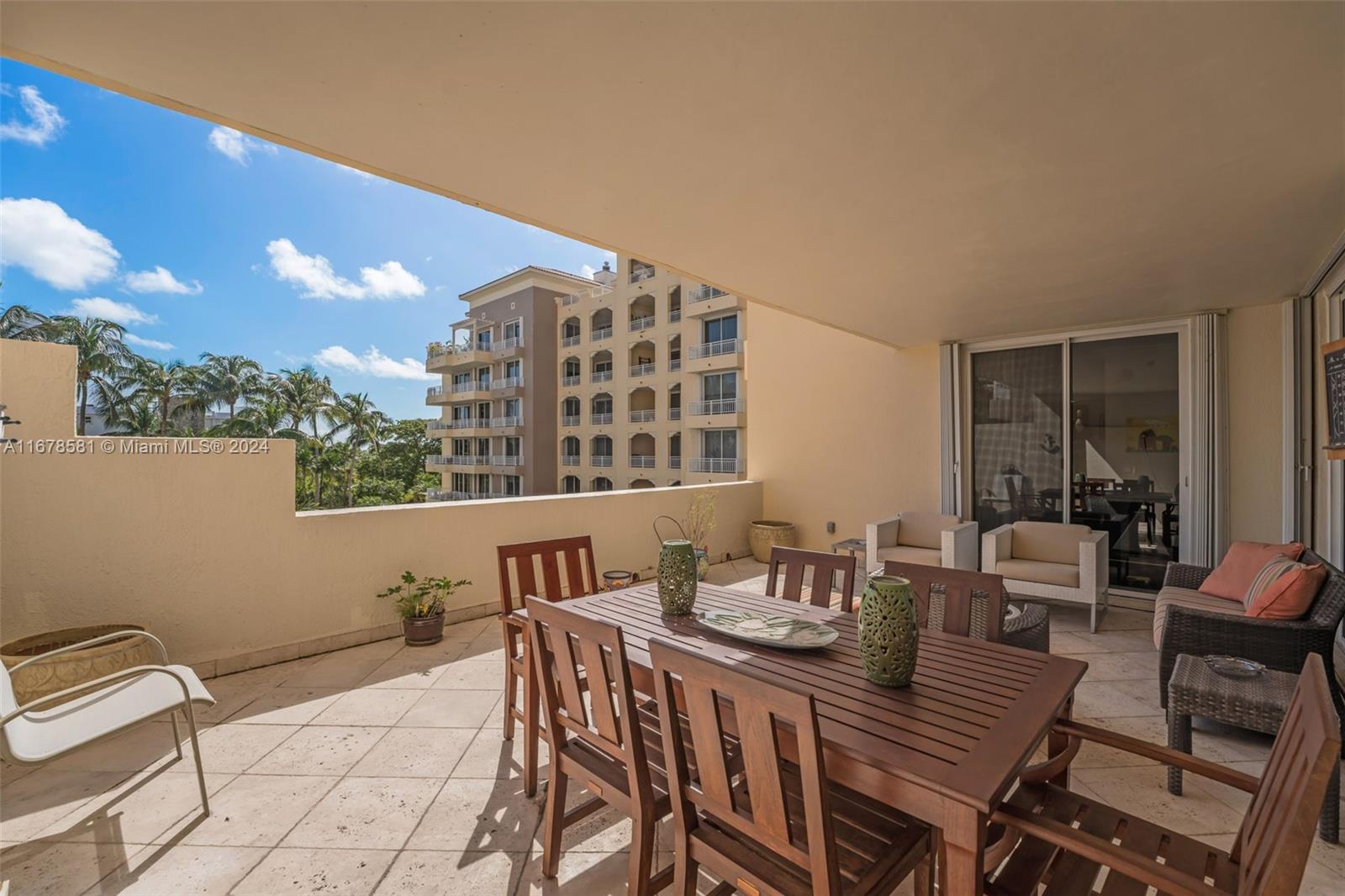 765 Crandon Boulevard, Unit 305 Key Biscayne, FL 33149 - Photo 30 of 55 a view of a dining room with furniture and chandelier