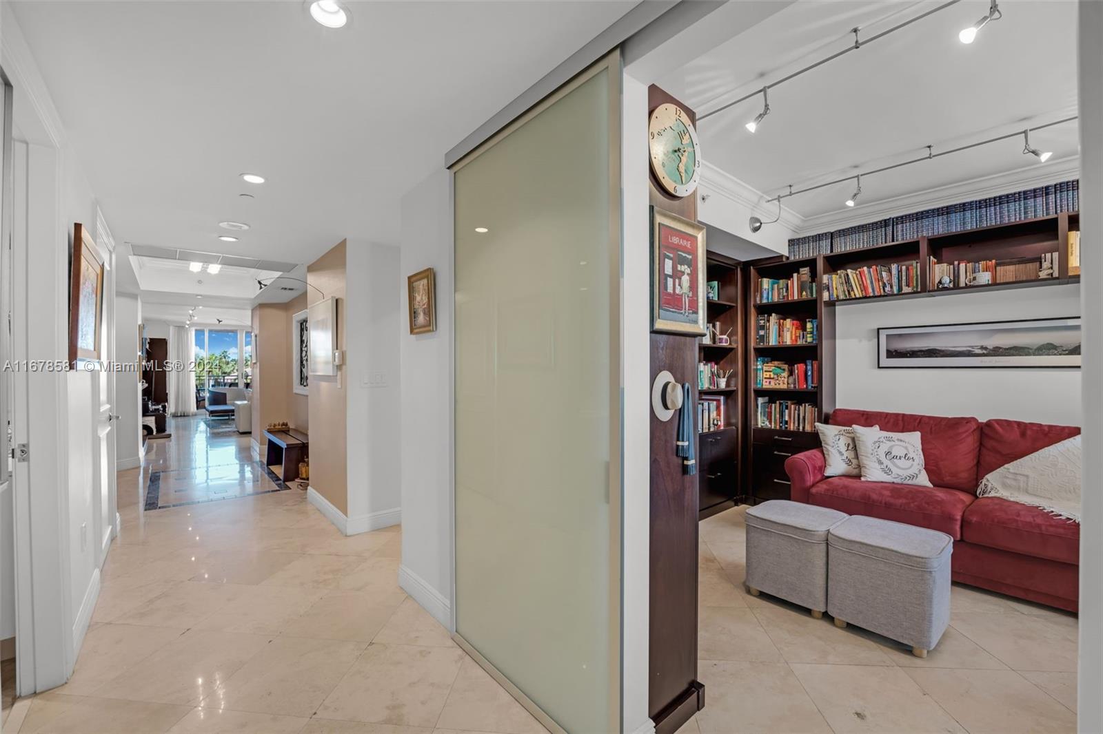 765 Crandon Boulevard, Unit 305 Key Biscayne, FL 33149 - Photo 35 of 55 a living room with furniture and a book shelf