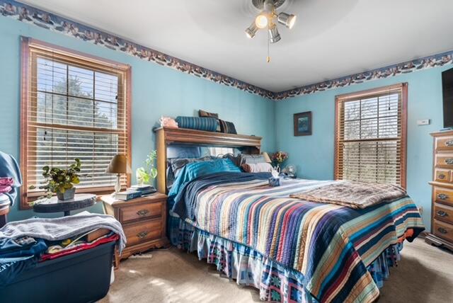 13318 Robin Lane Wheatfield, IN 46392 - Photo 14 of 17 a bedroom with bed and windows