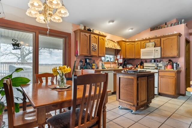13318 Robin Lane Wheatfield, IN 46392 - Photo 10 of 17 a kitchen with stainless steel appliances granite countertop a stove top oven a sink a dining table and chairs