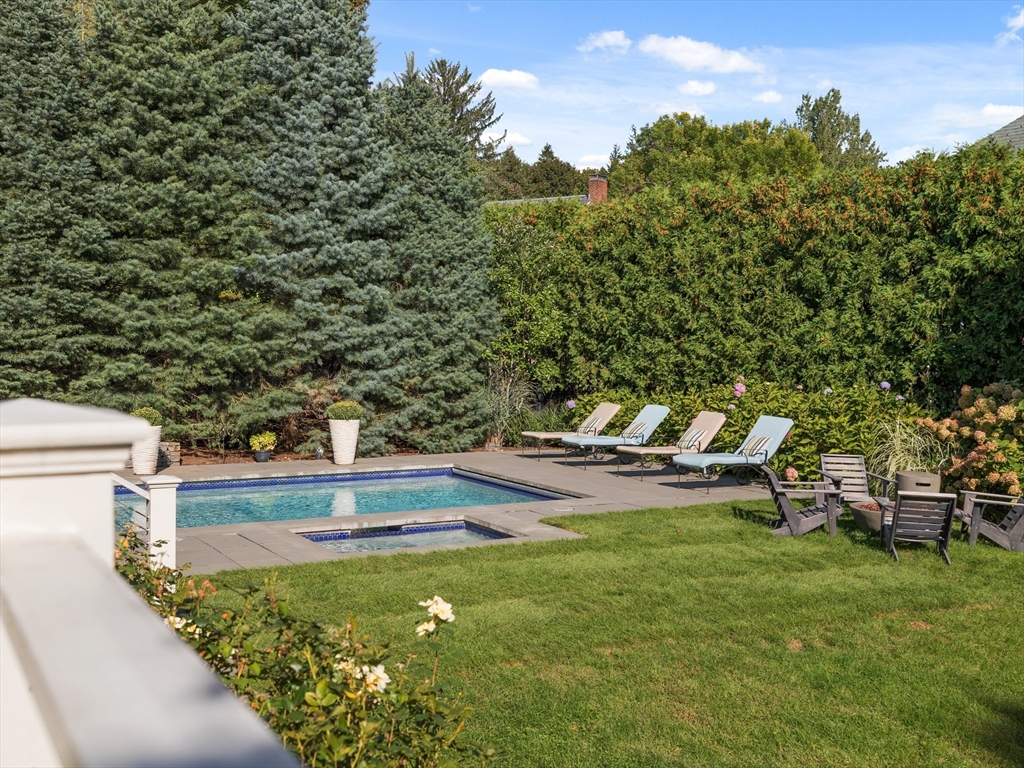98 Annawan Road Newton, MA 02468 - Photo 28 of 30 a view of a swimming pool with lawn chairs and a fire pit