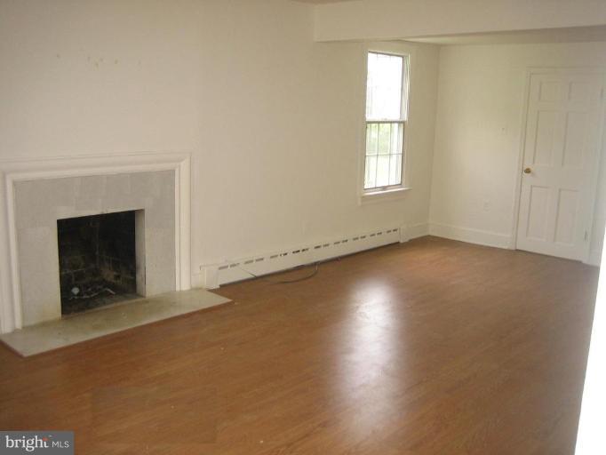 2115 Fairland Road Silver Spring, MD 20904 - Photo 14 of 16 an empty room with windows and fireplace
