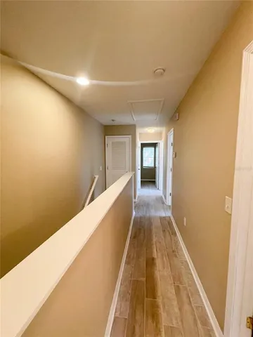a view of a hallway with wooden floor