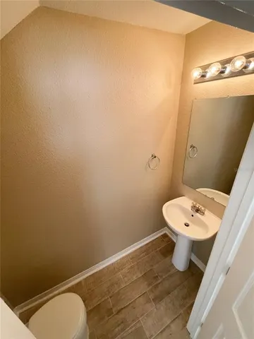 a white toilet sitting next to a bathroom sink