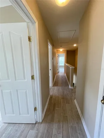 a view of a hallway with wooden floor