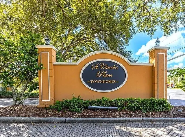 a sign that is on a brick wall