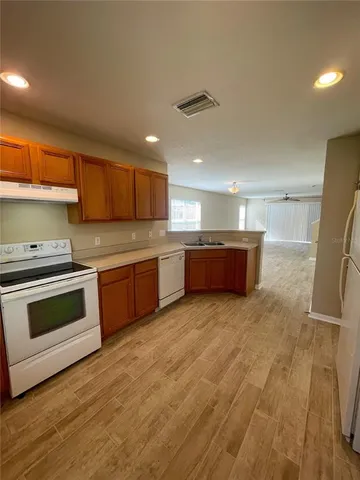 a kitchen with stainless steel appliances granite countertop a stove and a sink