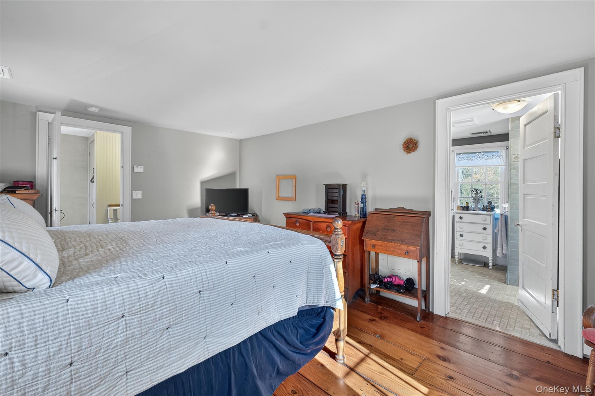 321 Burnt Meadow Road Gardiner, NY 12525 - Photo 15 of 46 a bedroom with a bed and wooden floor