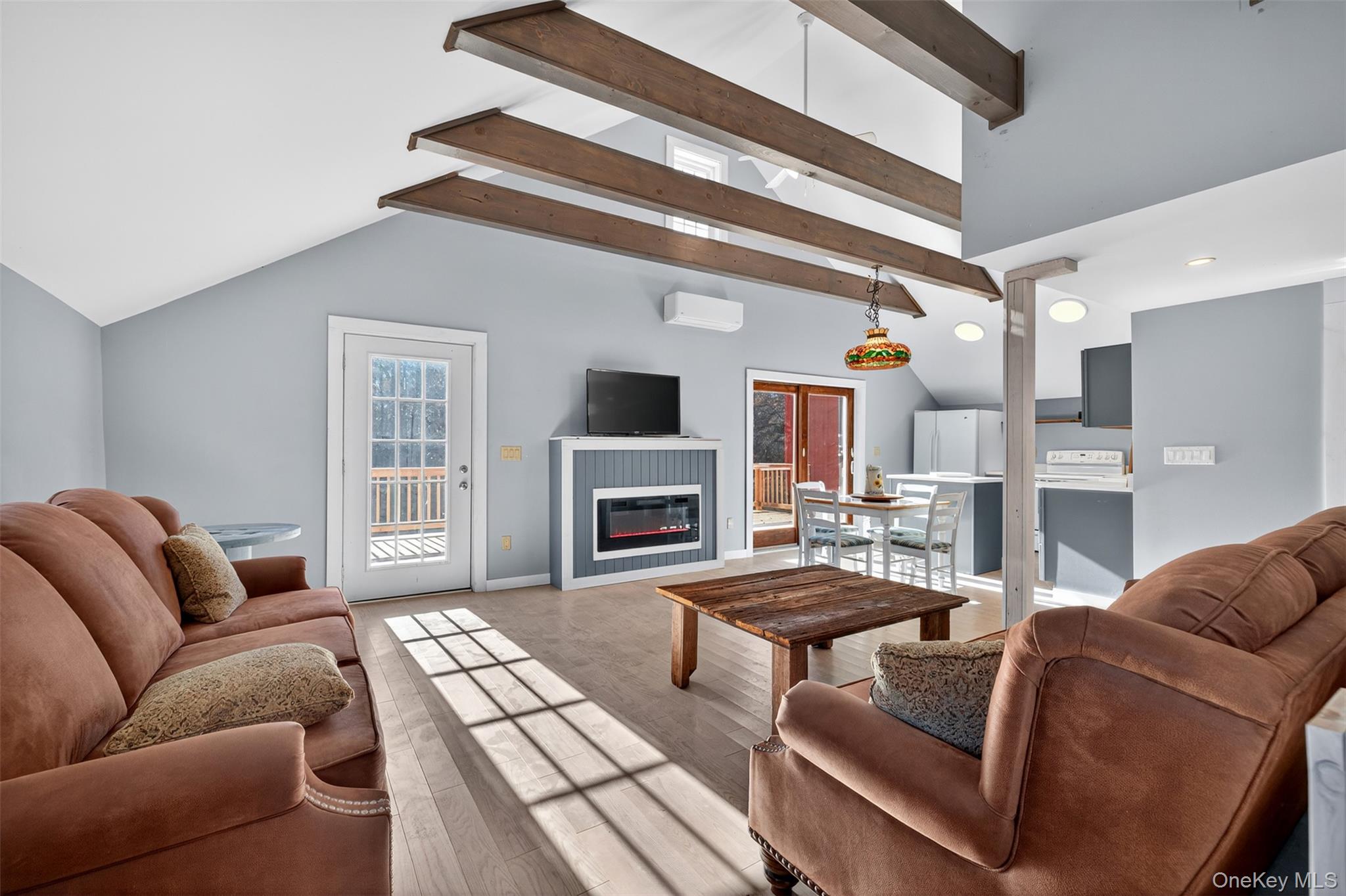 321 Burnt Meadow Road Gardiner, NY 12525 - Photo 23 of 46 a living room with furniture a fireplace and a flat screen tv