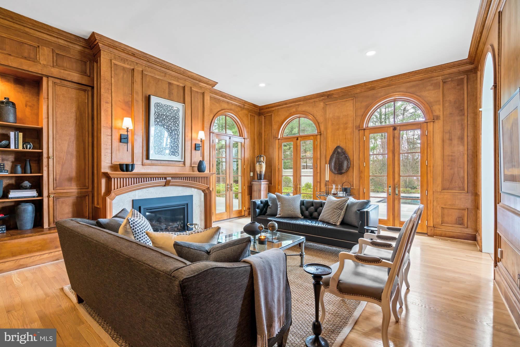 1198 Windrock Drive McLean, VA 22102 - Photo 18 of 83 a living room with furniture a fireplace and large windows