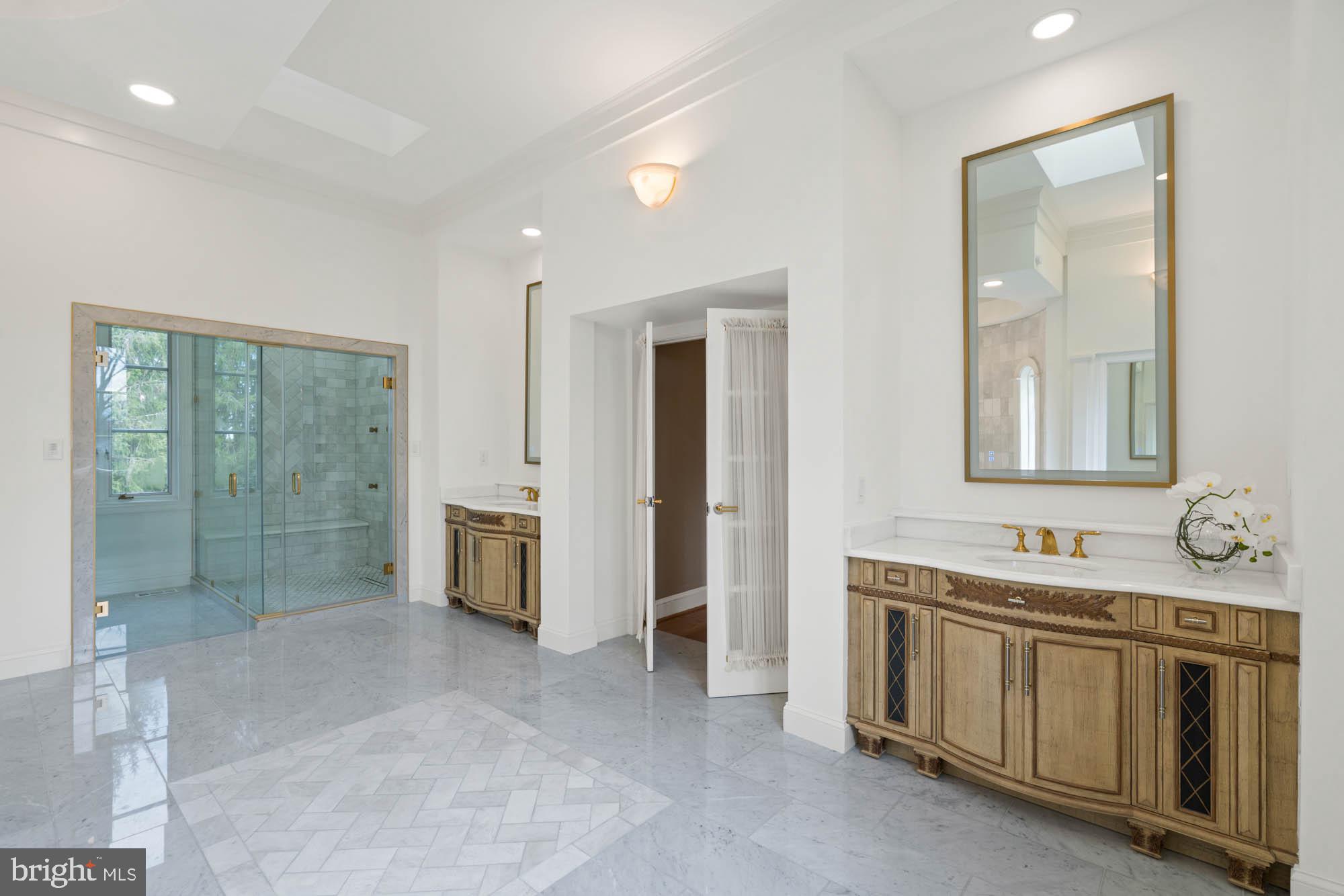 1198 Windrock Drive McLean, VA 22102 - Photo 44 of 83 a spacious bathroom with a double vanity sink a large mirror and a shower