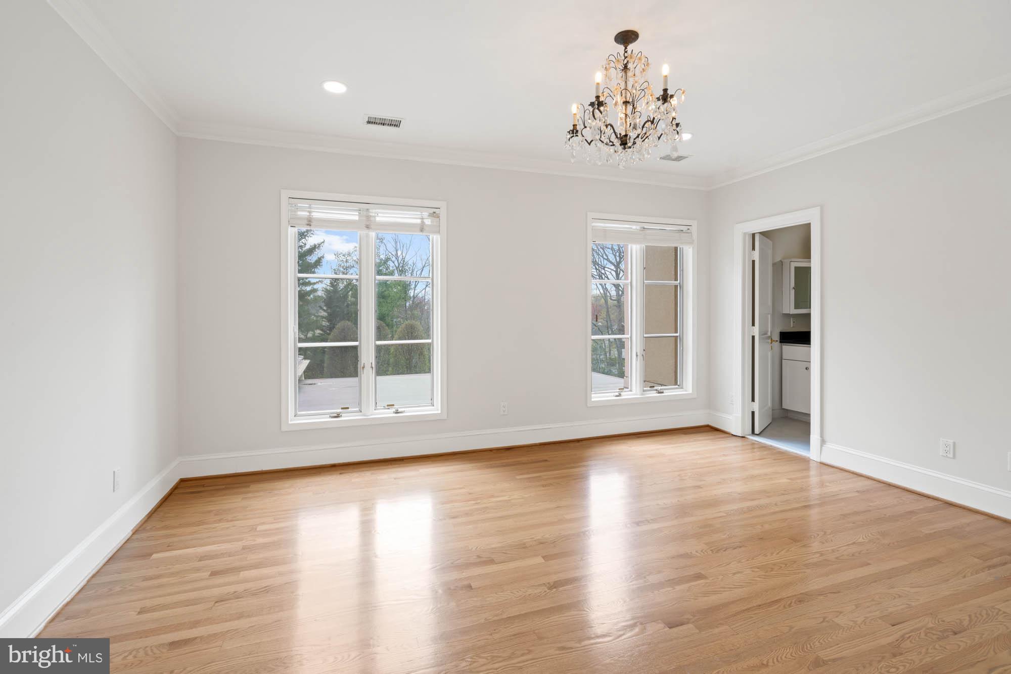 1198 Windrock Drive McLean, VA 22102 - Photo 53 of 83 an empty room with wooden floor chandelier and windows