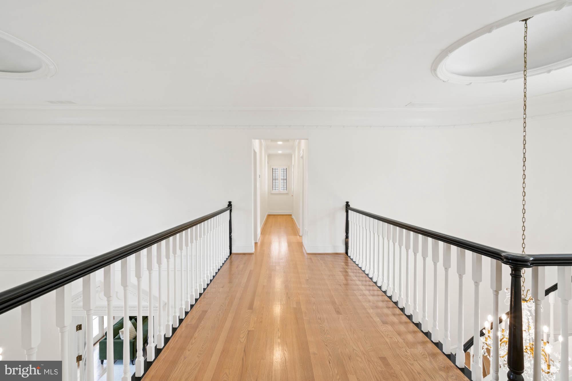 1198 Windrock Drive McLean, VA 22102 - Photo 54 of 83 a view of a hallway with wooden floor and staircase