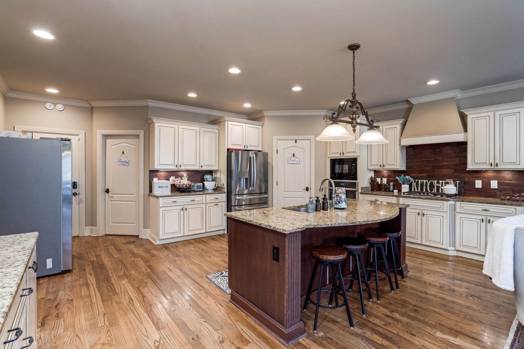 1629 Fair House Road Spring Hill, TN 37174 - Photo 12 of 42 a kitchen with stainless steel appliances kitchen island granite countertop a sink refrigerator and cabinets