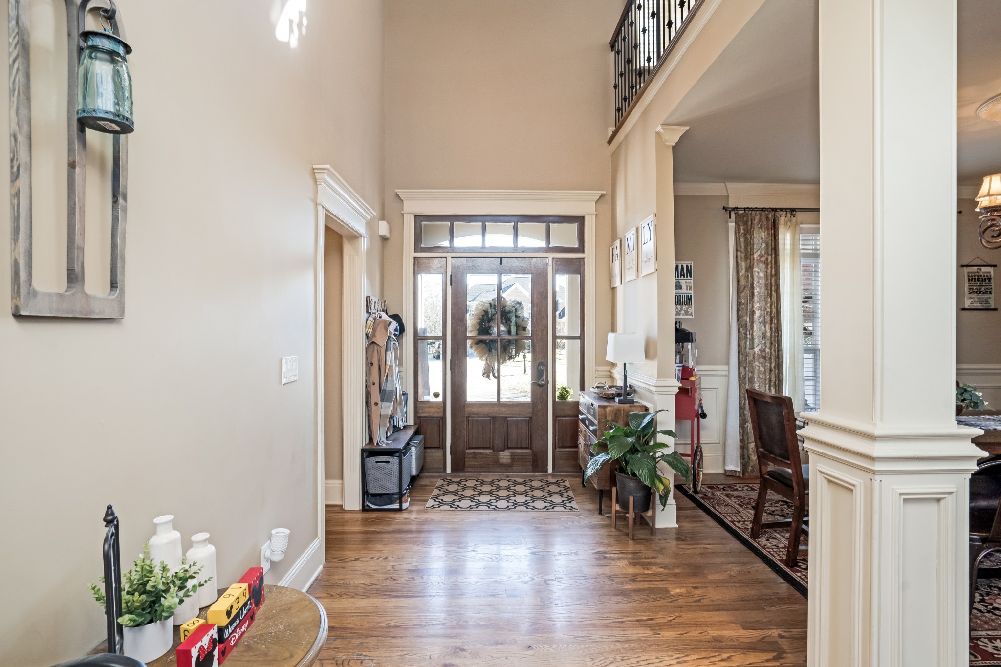 1629 Fair House Road Spring Hill, TN 37174 - Photo 7 of 42 a hallway with wooden floor and a potted plant