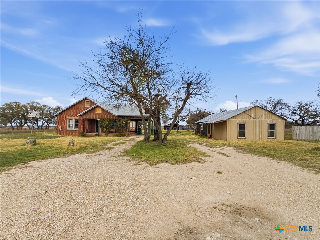 910 County Road 421 Evant, TX 76525 - Photo 1 of 25 a front view of a house with a yard