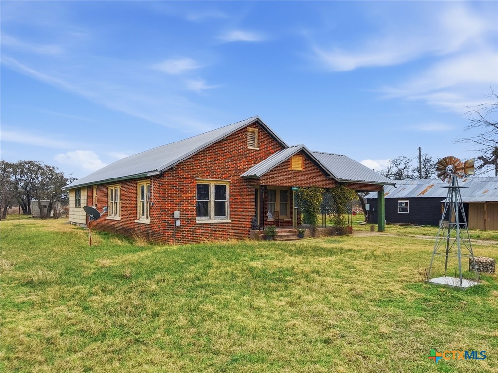 910 County Road 421 Evant, TX 76525 - Photo 11 of 25 a front view of a house with a yard