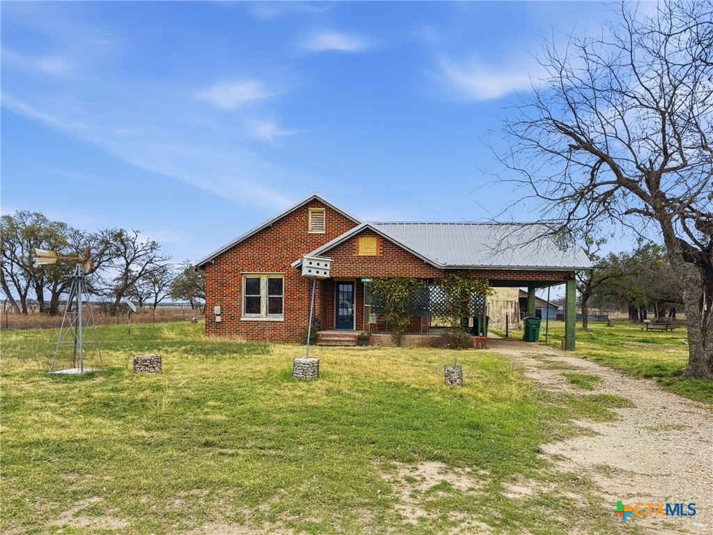 910 County Road 421 Evant, TX 76525 - Photo 2 of 25 a front view of a house with a yard table and chairs