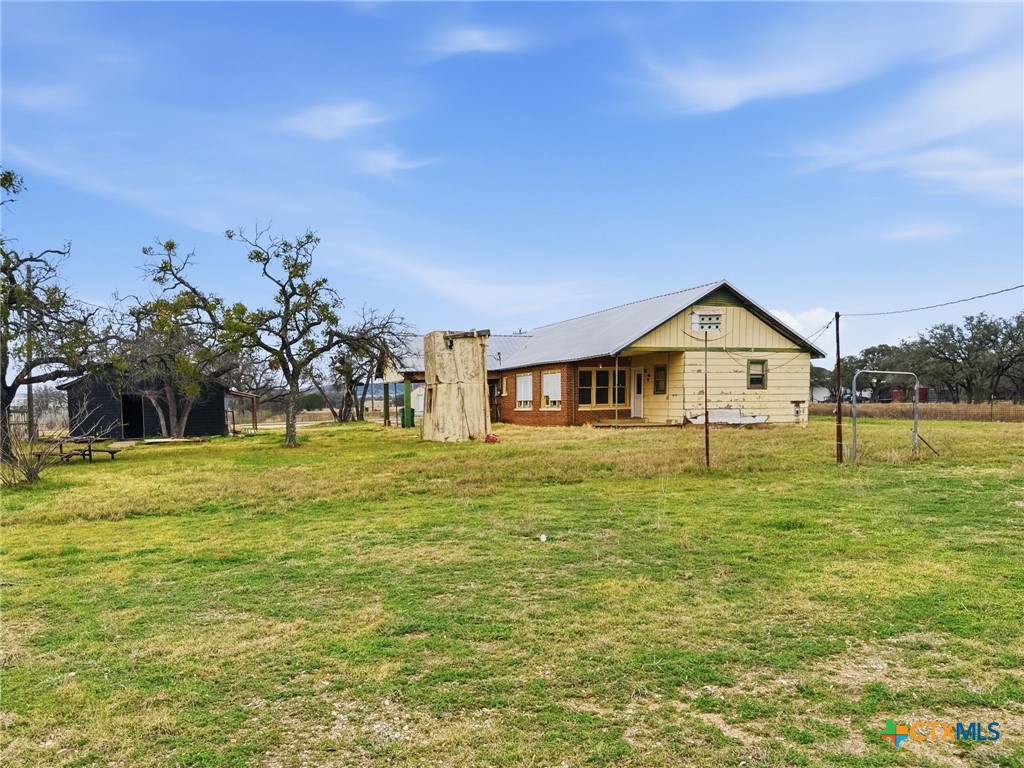 910 County Road 421 Evant, TX 76525 - Photo 9 of 25 a front view of house with yard and trees in the background
