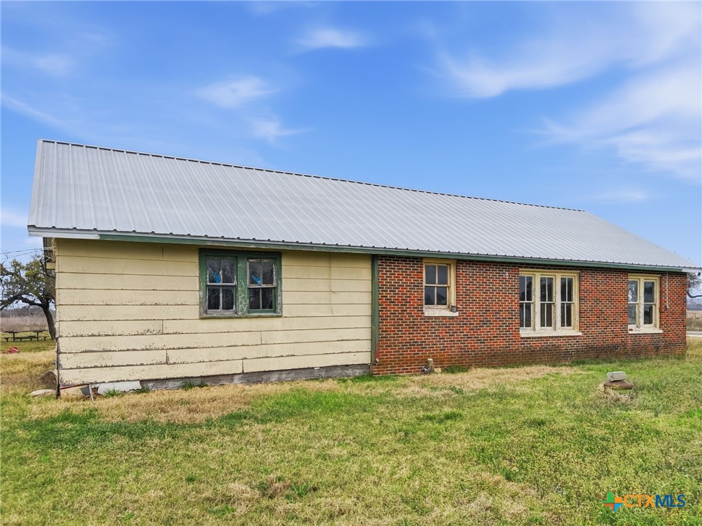 910 County Road 421 Evant, TX 76525 - Photo 10 of 25 a brick house with a yard