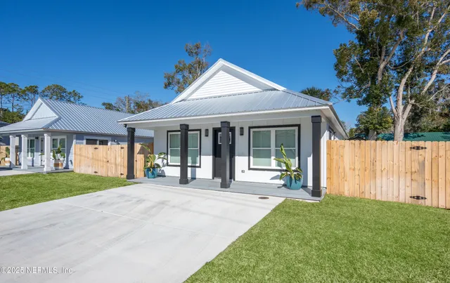 a front view of a house with a yard and porch