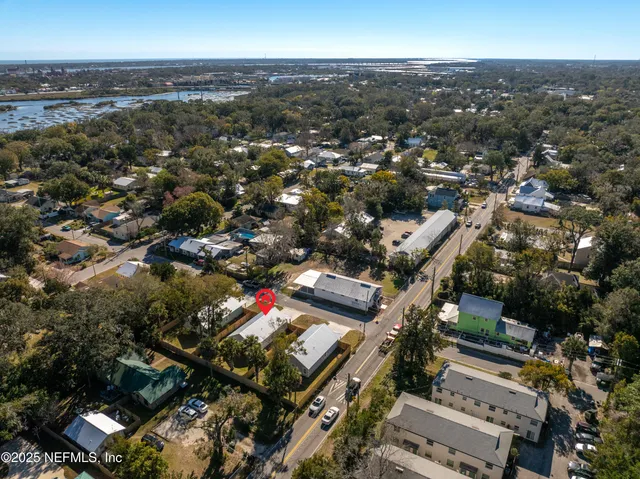 an empty room with wooden floor ceiling fan and windows