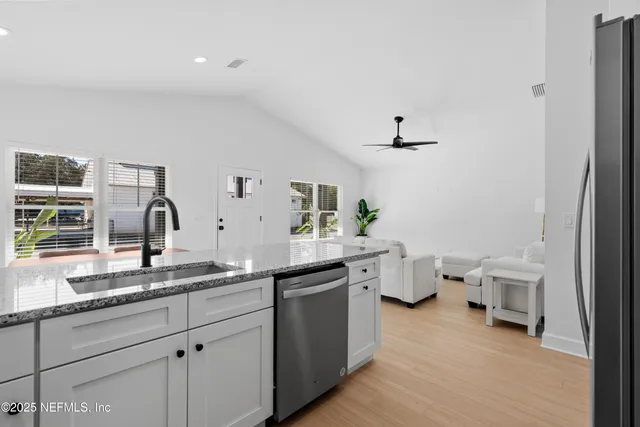 a spacious bathroom with a double vanity sink and a toilet