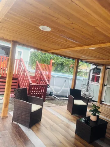 a living room with furniture and a floor to ceiling window